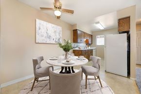 Modesto apartment for rent - A dining room with a table set and a ceiling fan above.