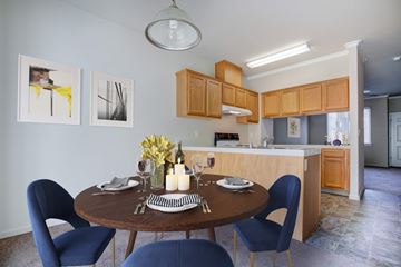 Coalinga apartment for rent - A dining room with a table set for two and a kitchen area in the background.