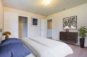 Coalinga apartment for rent - A bedroom with a bed, dresser, and a painting on the wall.