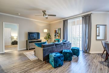 Orlando apartment for rent - A living room with a blue couch and a television.