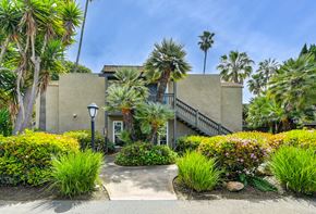 Carlsbad apartment for rent - a building with palm trees in front of it