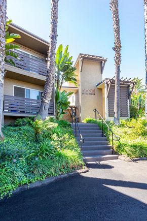 La Mesa apartment for rent - a building with stairs and palm trees in front of it