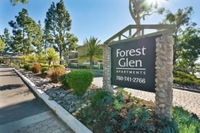 Escondido apartment for rent - A sign for Forest Glen Apartments stands in front of a row of trees and houses.