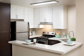 Escondido apartment for rent - A modern kitchen with white cabinets and a fridge