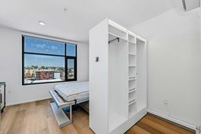 San Diego apartment for rent - pull out bed next to shelves on wood floor