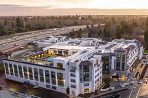 Sacramento apartment for rent - A large white building with a pool in the middle of it.