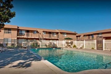 Kerman apartment for rent - A swimming pool in front of apartment buildings.