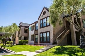 Henderson apartment for rent - Community exterior with windows, staircase, and beautiful green lawn.
