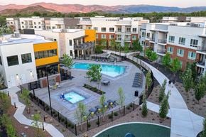 Reno apartment for rent - A pool surrounded by a fence and a building.
