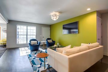Santee apartment for rent - A living room with a white couch and a blue chair.
