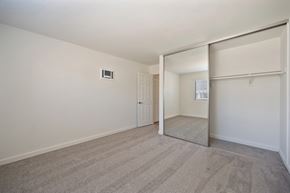 Carlsbad apartment for rent - an empty living room with a sliding glass door to a closet