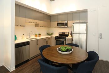Modern kitchens fully equipped with stainless steel appliances, including refrigerator, stove, dishwasher, microwave, and garbage disposal