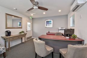 San Diego apartment for rent - a office with a desk and chairs and a mirror