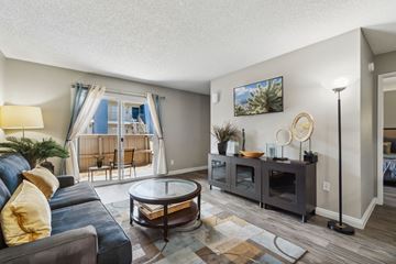 Mesa apartment for rent - A living room with a blue couch and a coffee table.