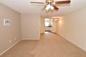 Oceanside apartment for rent - A room with a ceiling fan and carpeted floor.