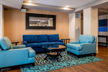 San Diego apartment for rent - A living room with a blue sofa and matching armchair.
