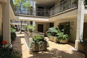San Diego apartment for rent - A courtyard with a balcony and potted plants.