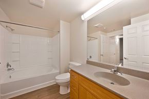 San Diego apartment for rent - A white bathroom with a toilet, sink, and bathtub.