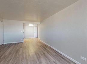 Aurora apartment for rent - A room with wooden flooring and white walls.