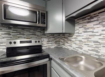 Aurora apartment for rent - A modern kitchen with a stainless steel oven and microwave.