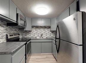 Aurora apartment for rent - A kitchen with a refrigerator, microwave, and oven.