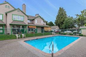 Des Moines apartment for rent - Pool with fence and lawn with view to property exterior and trees.