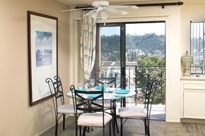 San Diego apartment for rent - A dining room with a table set for four and a view of the valley.