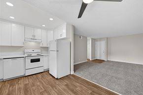 San Diego apartment for rent - A kitchen with white appliances and wooden floors.