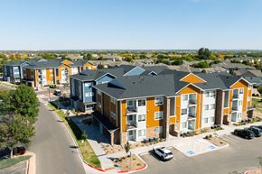 Fort Collins apartment for rent - A row of modern apartments with orange and blue accents.