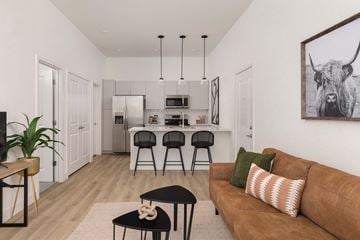 Fort Collins apartment for rent - A living room with a brown couch and a black coffee table.