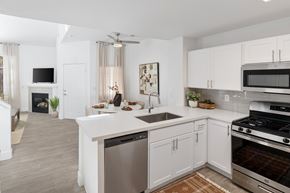 Las Vegas apartment for rent - A modern kitchen with white cabinets and stainless steel appliances.