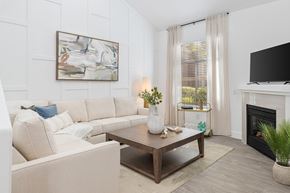 Las Vegas apartment for rent - A living room with a white couch and a painting on the wall.