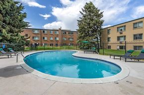 Greeley apartment for rent - A swimming pool in front of apartment buildings.