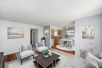 Hemet apartment for rent - A living room with a white couch and a coffee table.