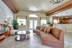Las Vegas apartment for rent - A community room with a couch, coffee table, and a chandelier.