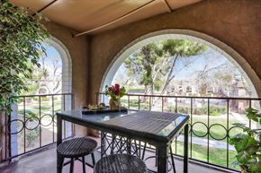 Las Vegas apartment for rent - A table with chairs and a vase of flowers on a balcony.