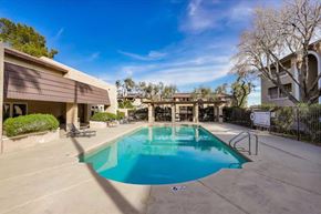 Las Vegas apartment for rent - A swimming pool in a residential area surrounded by a fence.