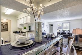 Las Vegas apartment for rent - A modern dining room with a glass table and chairs.