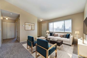 Manteca apartment for rent - A living room with a white couch and a grey rug.