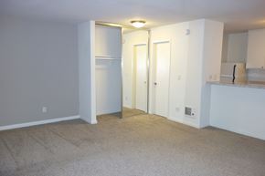 Solana Beach apartment for rent - an empty living room with white walls and a kitchen