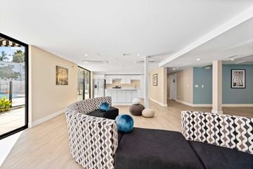 Sherman Oaks apartment for rent - A living room with a black and white patterned couch and a black rug.