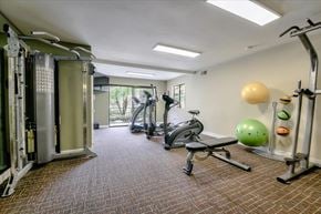 Escondido apartment for rent - A gym with a variety of equipment including a treadmill, weights, and a bench.