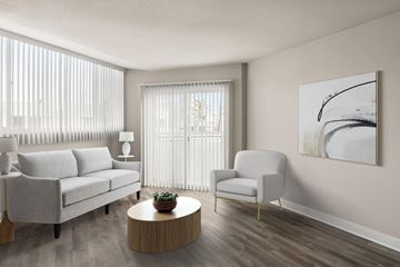 La Jolla apartment for rent - A living room with a grey couch, a white chair, a wooden coffee table, and a painting on the wall.