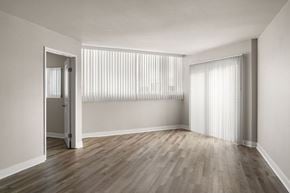 La Jolla apartment for rent - A room with wooden flooring and white walls.