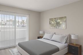 La Jolla apartment for rent - A bedroom with a large bed, a nightstand with a lamp, and a painting on the wall.