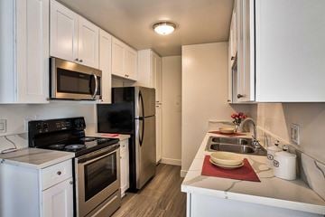 Sherman Oaks apartment for rent - A kitchen with white cabinets and appliances.