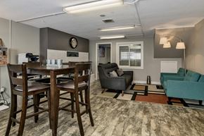 Lakewood apartment for rent - A community dining room with a wooden table and chairs.