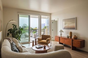 San Diego apartment for rent - A living room with a couch, a chair, a table, and a painting on the wall.