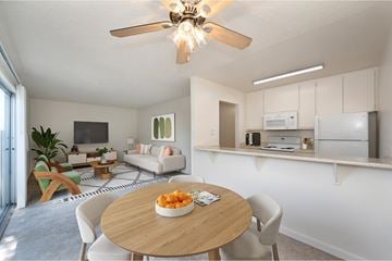Modesto apartment for rent - A modern living room with a dining table set in the middle.