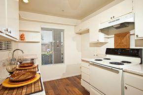 Vista apartment for rent - a kitchen with white appliances and white cabinets